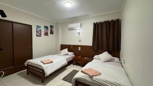 a bedroom with two beds and a window at Royal hotel Tanta - فندق رويال طنطا in Tanta