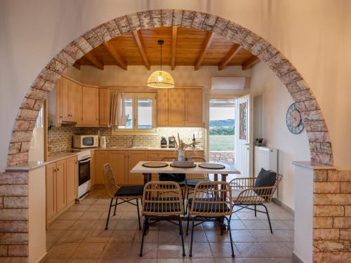 an archway in a kitchen with a table and chairs at Trip's House: εξοχικό σπίτι με θέα στη θάλασσα. in Ambelas