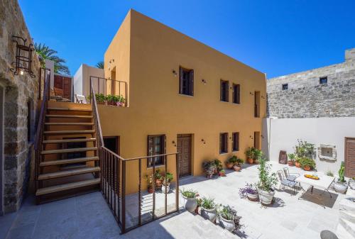 an exterior view of a house with a staircase at Spanish Knights Inn in Rhodes Town