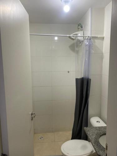 a bathroom with a shower with a toilet and a sink at Milenium residence 206 in Juiz de Fora