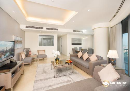 a living room with a couch and a tv at Deluxe - Address Dubai Mall - The Residence in Dubai