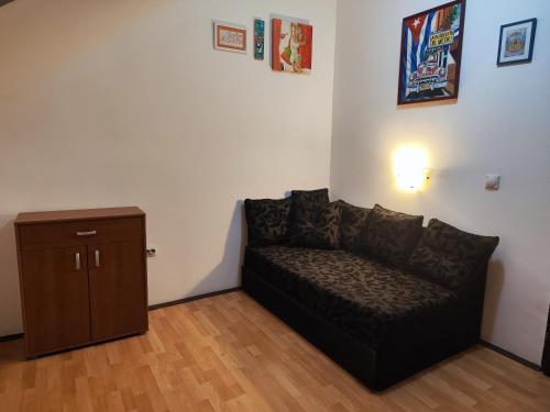 a living room with a couch and a cabinet at Zemun Centre Loft in Zemun