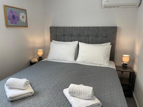 a bedroom with a bed with two towels on it at TERRA HOMERICA in Chios