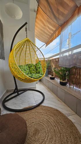 a bird cage hanging from a ceiling at Résidences C-Irène Angré in Abidjan