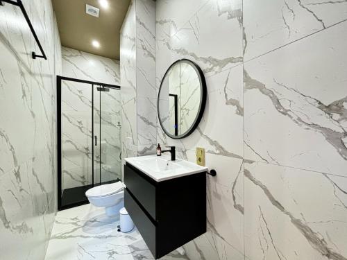 a bathroom with a sink and a mirror on the wall at Maison du Roi in Liège