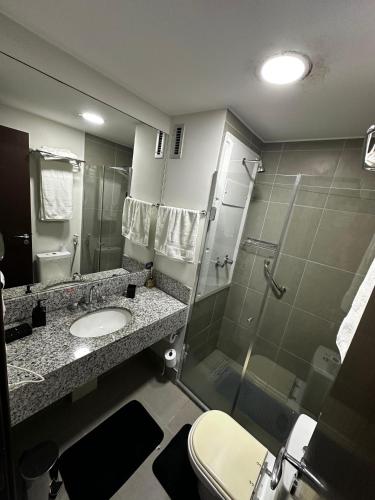 a bathroom with a shower and a sink and a toilet at Suíte Privativa Via Premiere - Barra Olímpica, Rio Centro, Rock in Rio, Carnaval in Rio de Janeiro