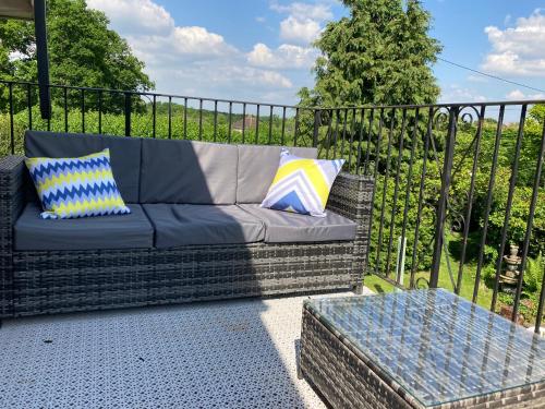 a couch sitting on a patio next to a fence at Longwood Forest Apartment in Bartley