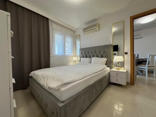 a bedroom with a large bed and a mirror at EL CANO MagicWorld MarinaDor in Oropesa del Mar