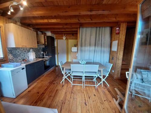 a kitchen and dining room with a table and chairs at CHALET 9 "Pensée" in Garin
