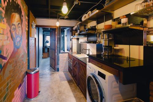a large kitchen with a washing machine in it at New York Loft & Japanese Magic by V4SKIN in Bangkok