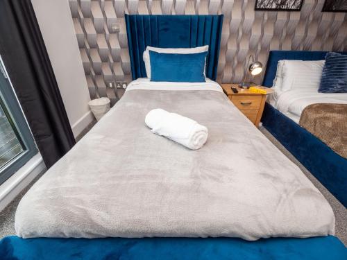 a large bed with a white towel on it at Central Birmingham Apartment with Balcony & Netflix in Birmingham