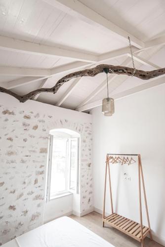 a room with a white ceiling and a window at Militiko in Himare