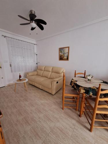 a living room with a couch and a table at Casa Rosalia in Orihuela Costa