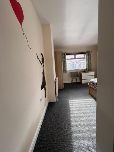 a room with a bed and a wall with a woman on the wall at 82a Underwood Lane in Crewe