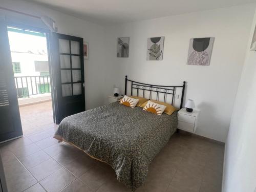 a bedroom with a bed with orange pillows on it at Casa La Estrella Playa Blanca Lanzarote in Playa Blanca