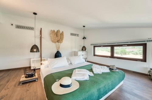 a bedroom with a bed with a hat on it at Villa Shangri-La Zakinthos in Zakynthos Town