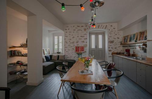 a kitchen and living room with a table and chairs at Militiko in Himare