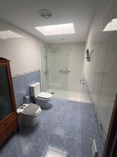 a bathroom with a toilet and a shower and a sink at Casa La Estrella Playa Blanca Lanzarote in Playa Blanca