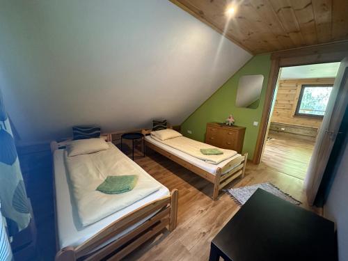 a small room with two beds and a table at Guļbūve ar saunu, kamīnu in Saulkrasti