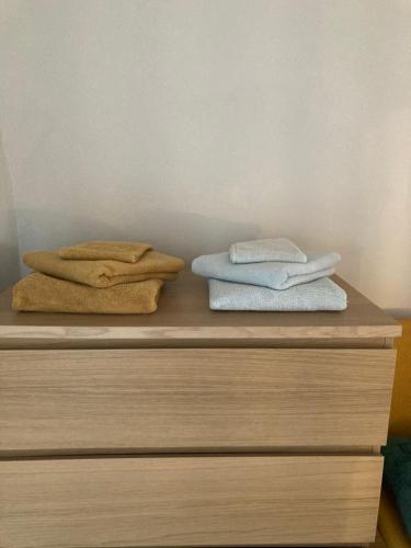 two towels are sitting on top of a dresser at A Casa Amarela Guesthouse in São Martinho da Cortiça