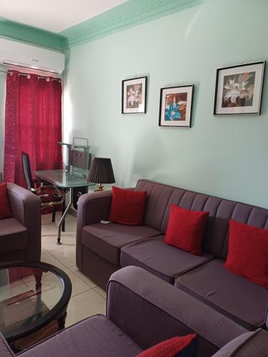 a living room with a couch and a table at Embassy deluxe 2 in Kingston