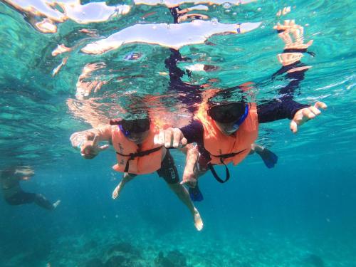 two people swimming in the water in the ocean at Departamento exclusivo en Puerto Vallarta in Ixtapa