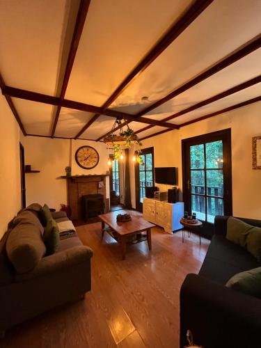a living room with a couch and a table at Retour aux Sources in Hastière-par-delà