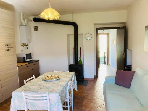 a living room with a table and a couch at Casa nella natura a Bobbio in Bobbio