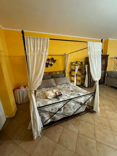 a bedroom with a bed with curtains on it at Taverna relais in Marco Simone