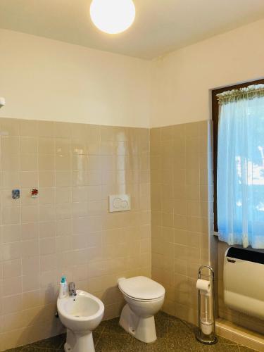 a bathroom with a toilet and a sink at Casa nella natura a Bobbio in Bobbio