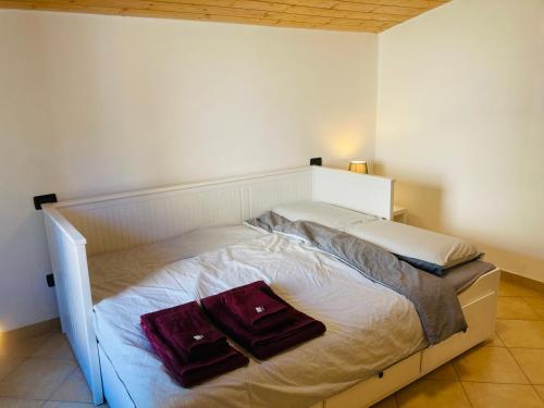 a bed with two pillows on it in a bedroom at Casa nella natura a Bobbio in Bobbio