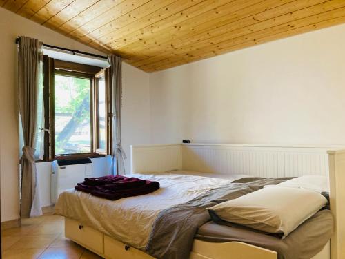a bedroom with a bed with a wooden ceiling at Casa nella natura a Bobbio in Bobbio