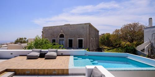 a swimming pool on the roof of a house at Secret Spot Luxury Villa in Fira