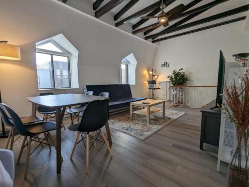 a living room with a table and chairs at 2 Bedrooms, 1 Sofa bed and 1,5 Bathrooms, Renovated Apartment in the Heart of Plateau Mont-Royal in Montréal