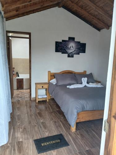 a bedroom with a bed and a bathroom at glamping volvere san GabrieL 