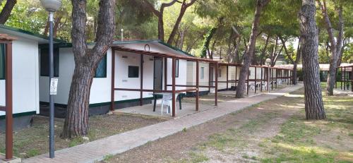 a row of houses with trees in the background at Villaggio Costa d'Argento in San Vito Chietino