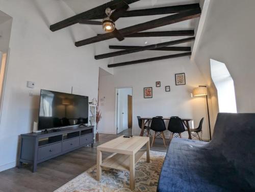 a living room with a couch and a tv and a table at 2 Bedrooms, 1 Sofa bed and 1,5 Bathrooms, Renovated Apartment in the Heart of Plateau Mont-Royal in Montréal