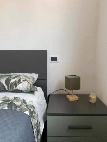a bedroom with a bed and a lamp on a nightstand at Casa Elefantino in Acilia