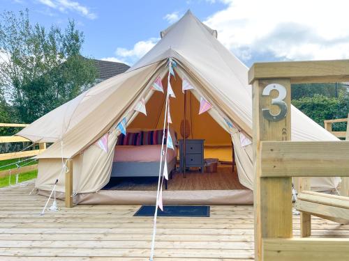 a large white tent with a bed in it at Greystones Glamping - Tent 1 in Greystones