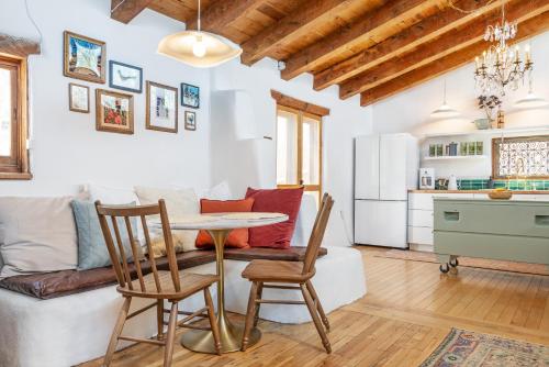 a kitchen and a living room with a table and chairs at Heart of Santa Fe - Adorable Hideaway - King and Queen - Walk to Everything - Fireplace - AC in Santa Fe
