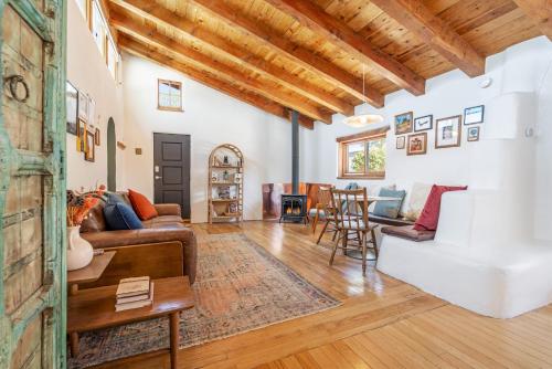 a living room with a couch and a table at Heart of Santa Fe - Adorable Hideaway - King and Queen - Walk to Everything - Fireplace - AC in Santa Fe