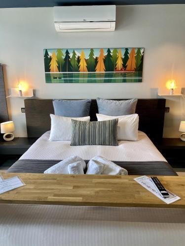 a bedroom with a large bed with two pillows at Les Suites du Lac in Aix-les-Bains