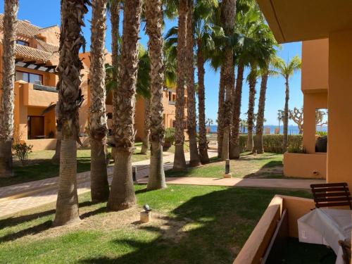a park with palm trees and a fire hydrant at Casa Allegra in Los Alcázares