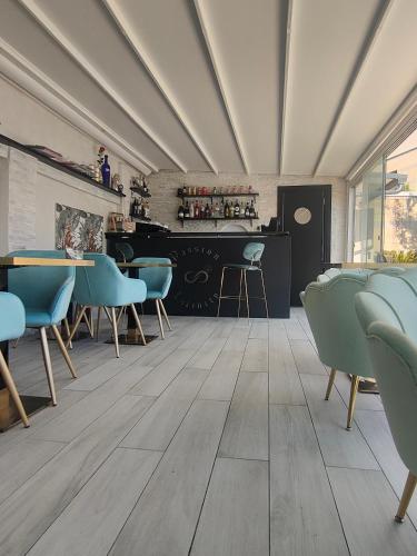 a room with a table and chairs and a bar at Infinity Passion in Rho