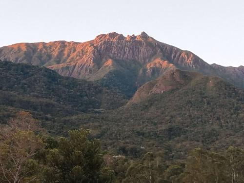a view of a mountain with trees in the foreground at Cabana nas montanhas! in Resende