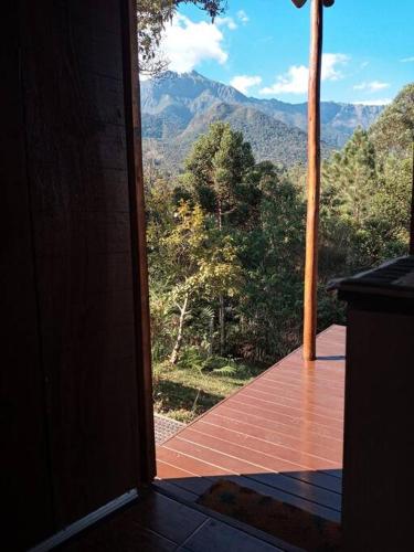 an open door to a balcony with a view of a mountain at Cabana nas montanhas! in Resende
