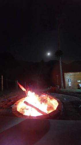 a large fire in the street at night at Cabana nas montanhas! in Resende