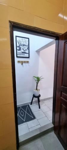 a room with a potted plant sitting on a table at Résidences C-Irène Angré in Abidjan