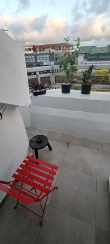 a red chair sitting on top of a roof at Résidences C-Irène Angré in Abidjan