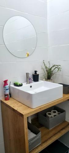 a bathroom with a white sink and a mirror at Résidences C-Irène Angré in Abidjan